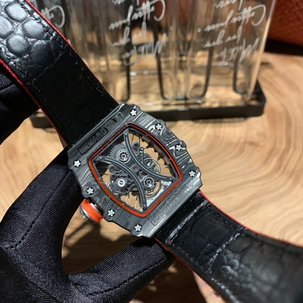 Richard Mille watch with black leather strap, square skeleton dial, red bezel outline, black case