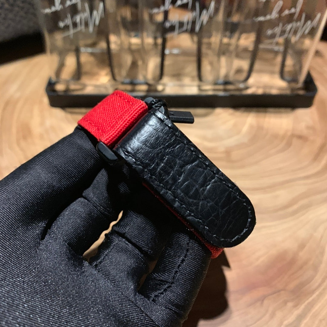 Richard Mille watch strap end, black textured leather with red lining strip and buckle