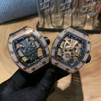 Pair of square luxury watches, black straps, diamond bezels, skeleton dials