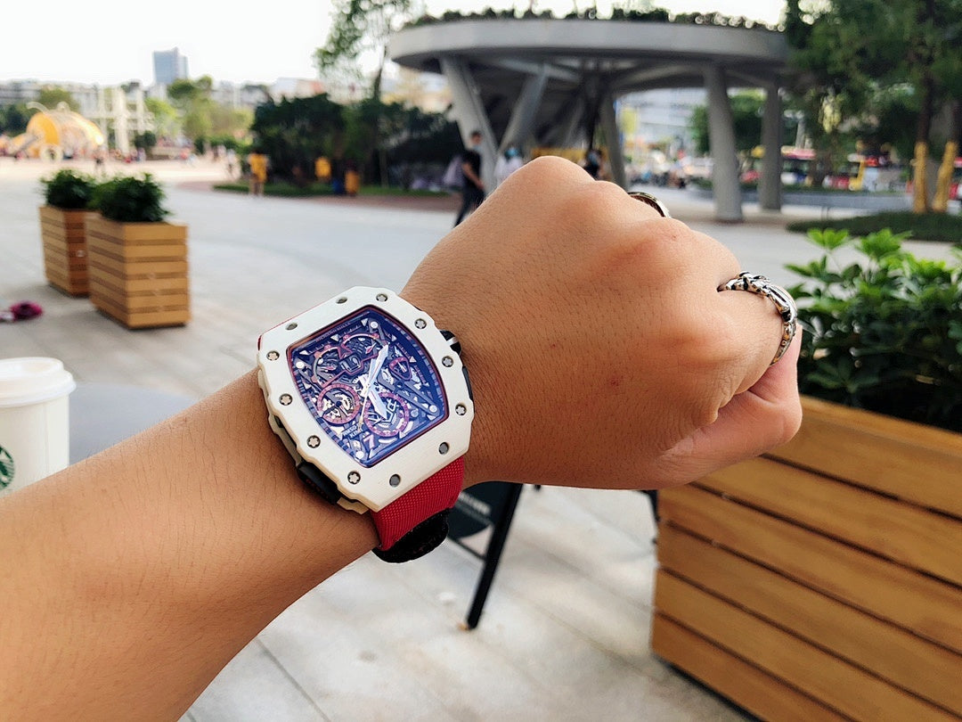 Richard Mille wristwatch on wrist, red strap and light case with open skeleton dial
