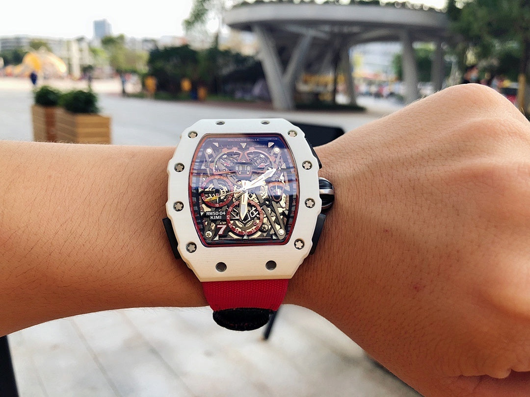 Richard Mille wristwatch close-up on wrist, light case and red strap, skeleton dial