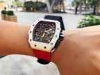 Richard Mille wristwatch on wrist, red strap and light case with exposed dial components