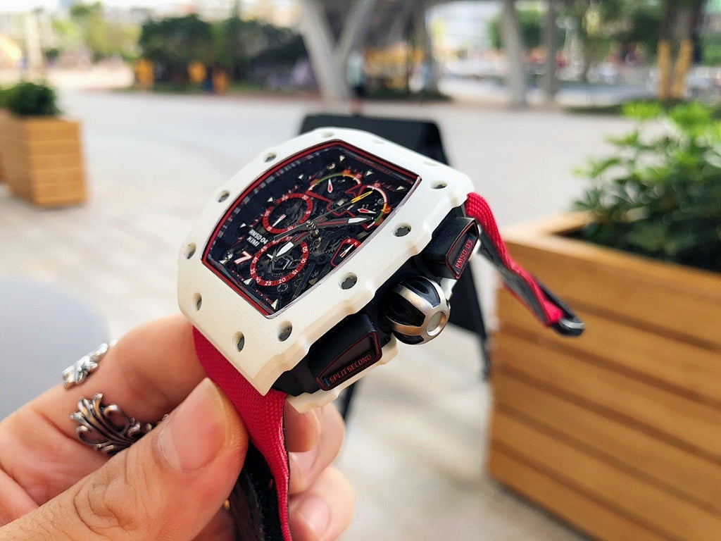 Richard Mille wristwatch side view, red strap with light case and black crown guard