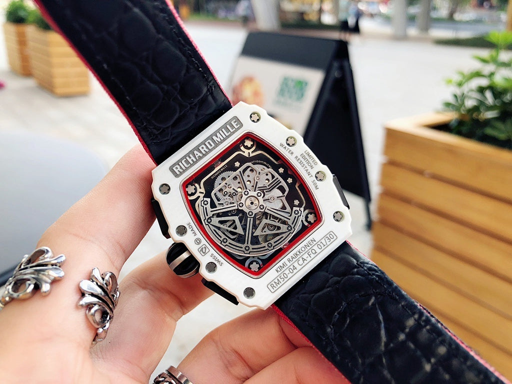 Richard Mille wristwatch back view, engraved light case with black strap and red lining