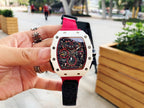 Richard Mille wristwatch front view in hand, red strap and light case with skeleton dial