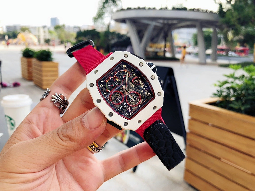 Richard Mille wristwatch angled view, red strap with light case and black skeleton dial