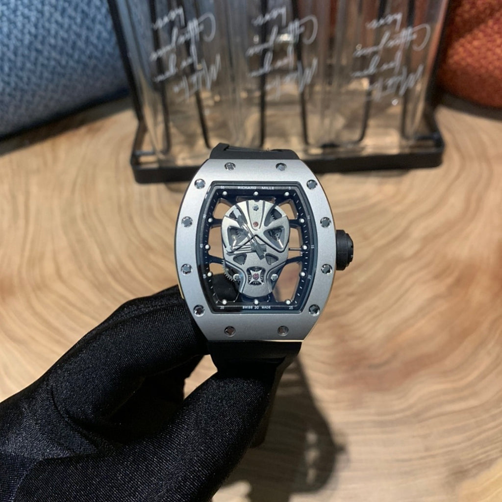 Richard Mille watch, centered front view with silver case, black bezel, skeleton dial