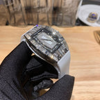 Richard Mille watch, white strap and diamond-set bezel, square dial with metal details.