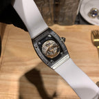 Richard Mille watch caseback, white strap, metal frame with movement window.