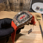 Richard Mille watch angled view on red-orange rubber strap with jeweled bezel