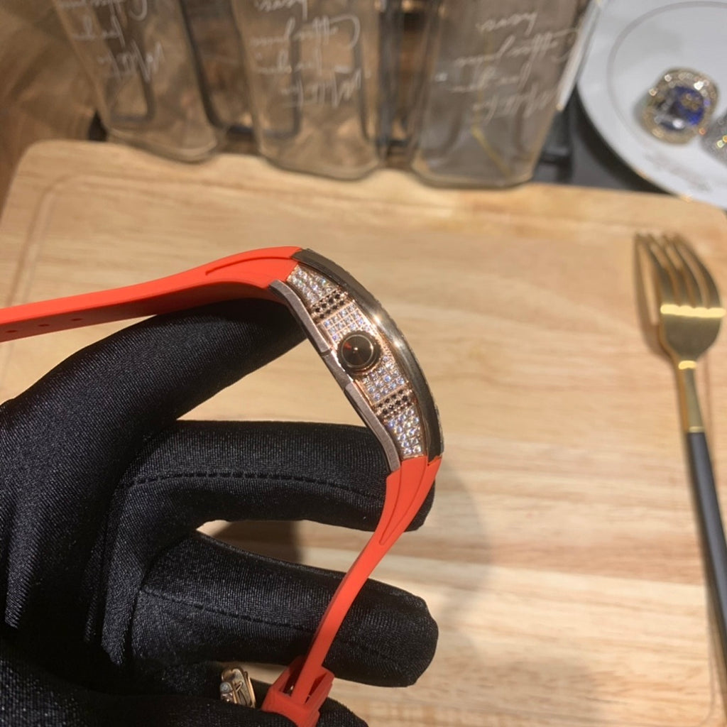 Richard Mille watch side profile with red-orange strap and jeweled bezel