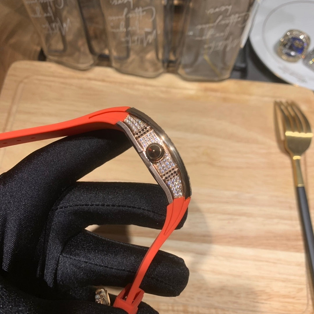 Richard Mille watch side profile with red-orange strap and jeweled bezel