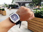 Richard Mille wristwatch on wrist, white case, black rubber strap, skeleton dial