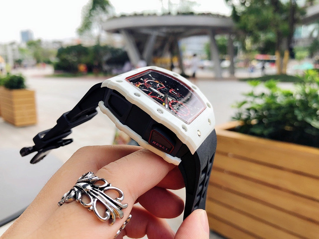 Richard Mille wristwatch side view, white case with skeleton dial, black rubber strap