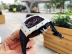 Richard Mille wristwatch on hand, angled view of white case, black rubber strap