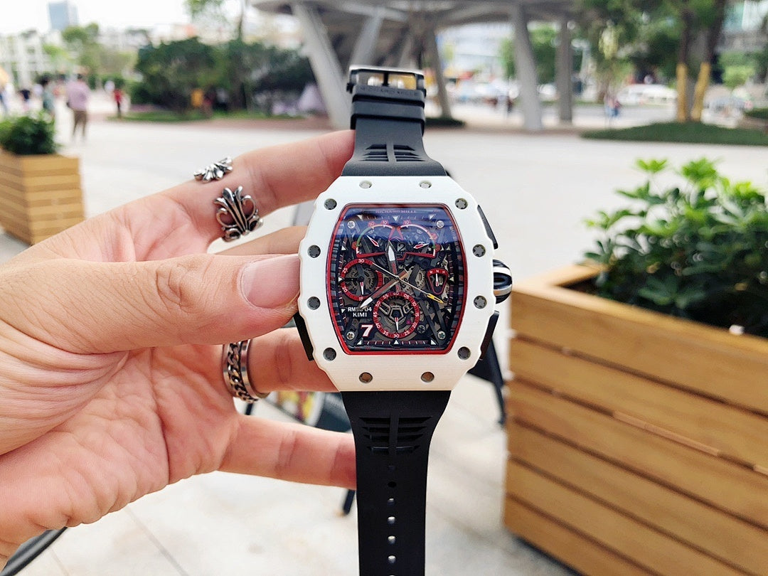 Richard Mille wristwatch with white case and black rubber strap, crown visible, skeleton dial