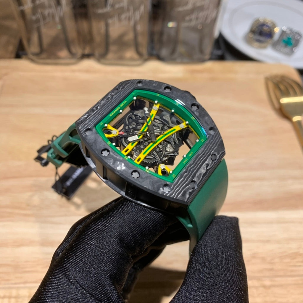 Three-quarter view square skeleton watch with green bezel, dark case, and green rubber strap