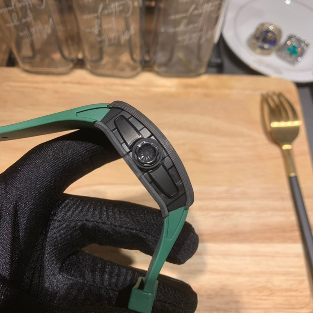 Side view of square wristwatch with dark crown and green rubber strap