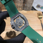 Back of watch case with engraved details and green rubber strap, silver-toned hardware