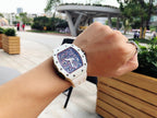 Richard Mille watch on wrist, white case with skeleton dial and perforated strap