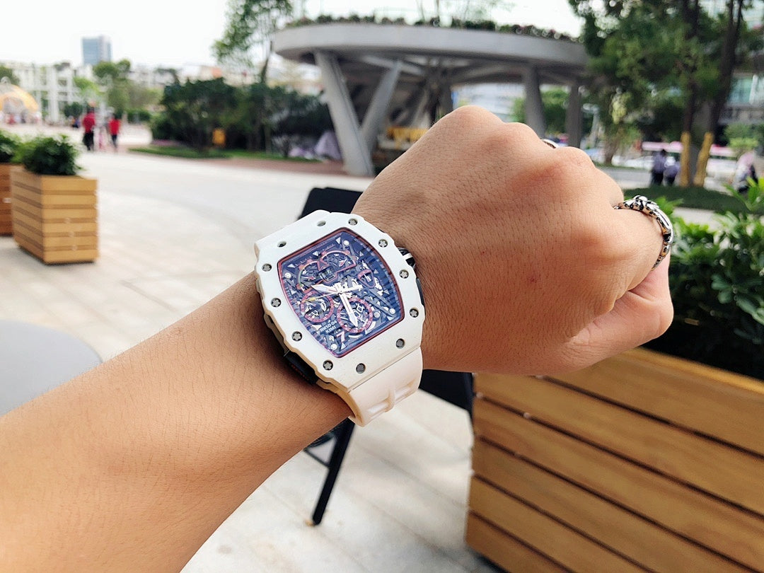 Richard Mille watch on wrist, white case with skeleton dial and perforated strap