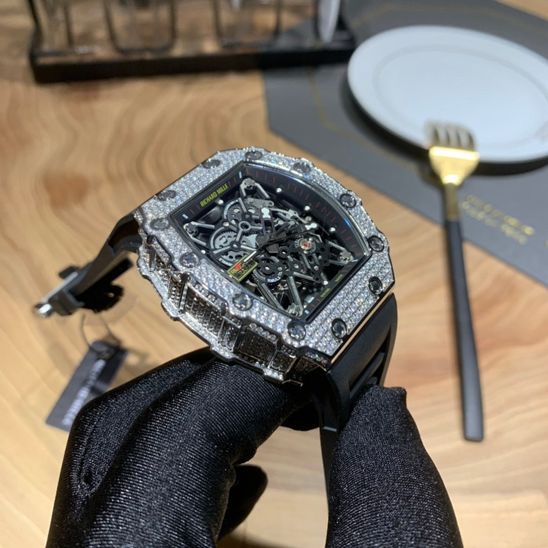 Skeleton dial watch with black band and jeweled bezel, side angle