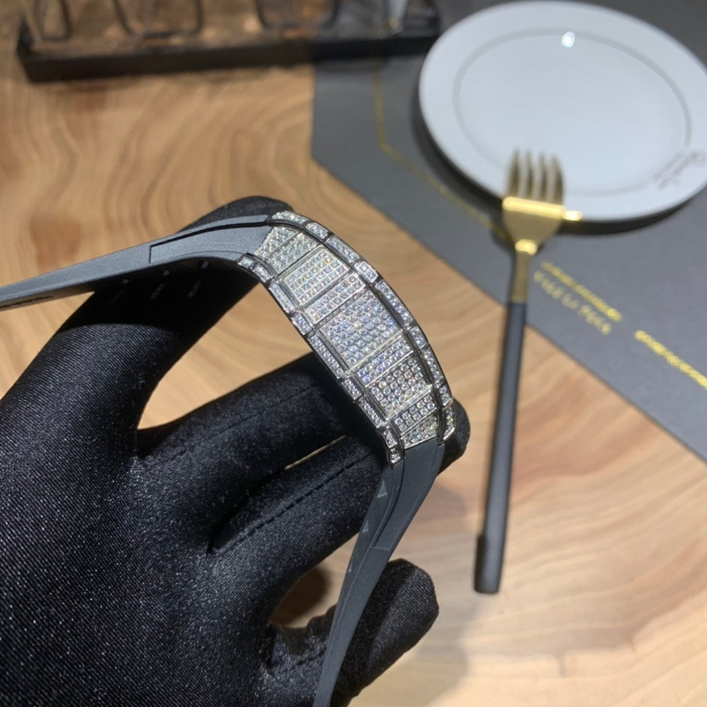 Jeweled bezel watch on black strap, close-up of case