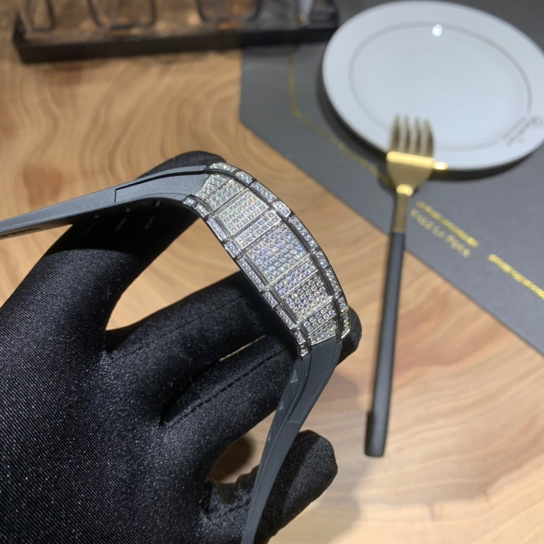 Jeweled bezel watch on black strap, close-up of case