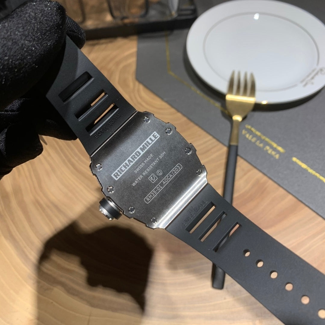 Richard Mille watch case on black strap, metal back detail visible
