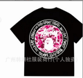 Black Stussy T-shirt with large circular graphic and pink camo face print