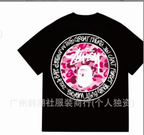 Black Stussy T-shirt with large circular graphic and pink camo face print
