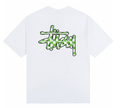 Stussy white T-shirt with green graffiti-style graphic logo on chest