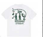 White T-shirt with green back graphic and “STUSSY Worldwide” lettering