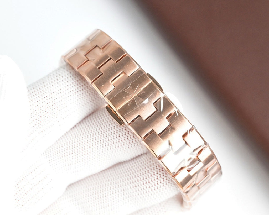 Rose gold-tone metal bracelet and case side view of a wristwatch