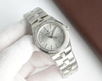Vacheron Constantin wristwatch with white dial, diamond bezel, steel bracelet
