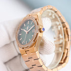 Rose gold wristwatch with green dial, diamond bezel, and blue gemstone crown