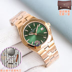Gold-toned wristwatch with green dial and metal link bracelet, date window at 3