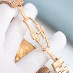Gold-tone metal watch bracelet with polished link links and clasp detail