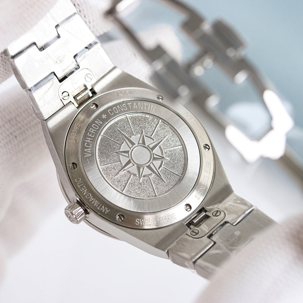 Engraved case back on a stainless steel wristwatch with a sunburst medallion.