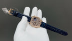 Vacheron Constantin watch angled view with blue leather strap and rose-gold tone case