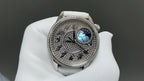 Vacheron Constantin watch with ornate dark dial, blue moon accent, white leather strap