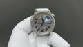 Vacheron Constantin watch with dark engraved dial and blue moon motif, white leather strap