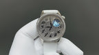 Vacheron Constantin watch with dark engraved dial and blue moon motif, white leather strap