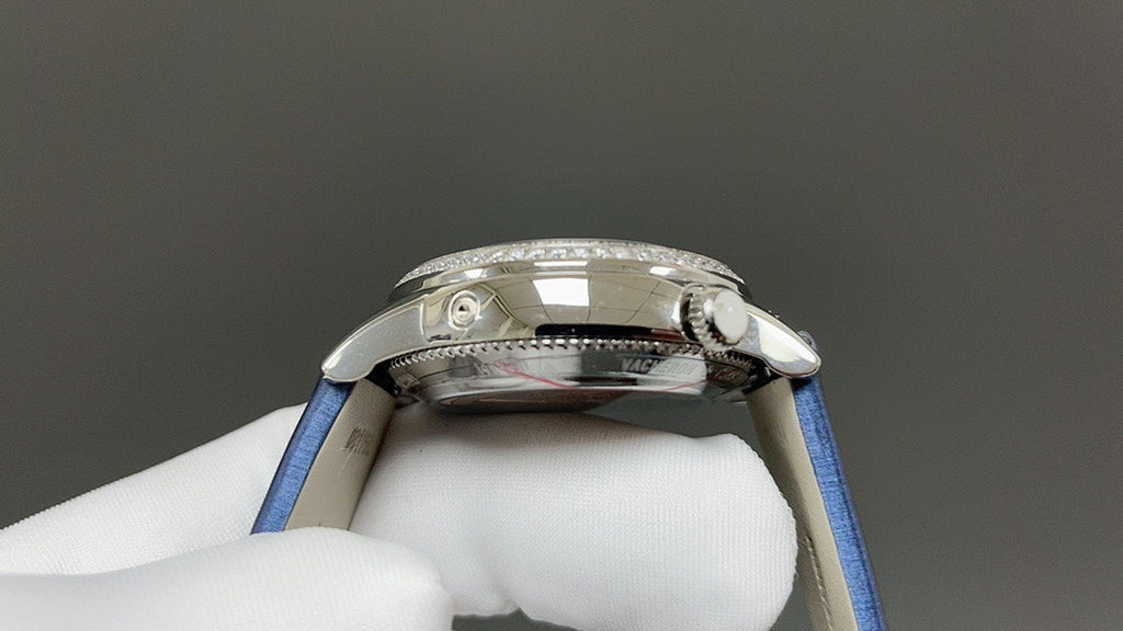 Luxury wristwatch side view with crown detail and polished silver case, blue strap