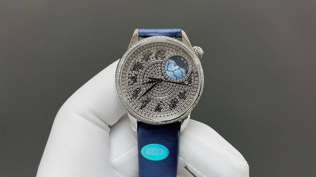 Luxury wristwatch with blue leather strap and ornate silver dial with blue globe detail