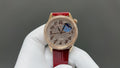 Vacheron Constantin watch with red leather strap, blue dial, and gold-tone case