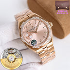 Rose-gold-tone wristwatch with diamond bezel, white dial, and metal link bracelet