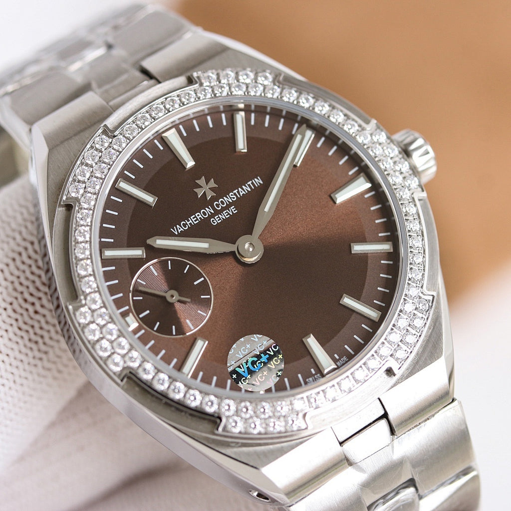 Stainless steel wristwatch with brown dial, jeweled bezel, and dual subdials
