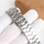 Steel wristwatch bracelet close-up with polished and brushed metal links