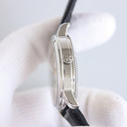 Vacheron Constantin wristwatch side view with silver case and black leather strap